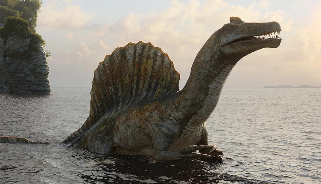 Dinossauro recriado digitalmente emerge da água em cena de Os Dinossauros.